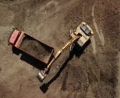 aerial-view-of-excavator-pours-sand-into-the-truck-AXX2FN4.mov from the mov