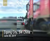 A female scooter driver narrowly escaped death after being run over by a truck in southwestern China. The terrifying video, filmed in Zigong City in Sichuan Province on June 28, shows a scooter driving in front of a truck and then stopping at an intersection for the traffic lights.
