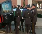 Friends and relatives of a policeman gunned down along with his partner have been joined by hundreds of uniformed officers at his wake on Friday.